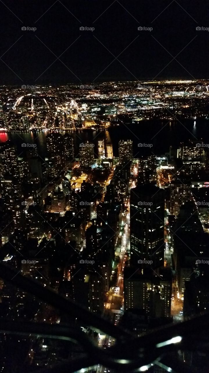 A nighttime overview of New York City from atop the Empire State Building.