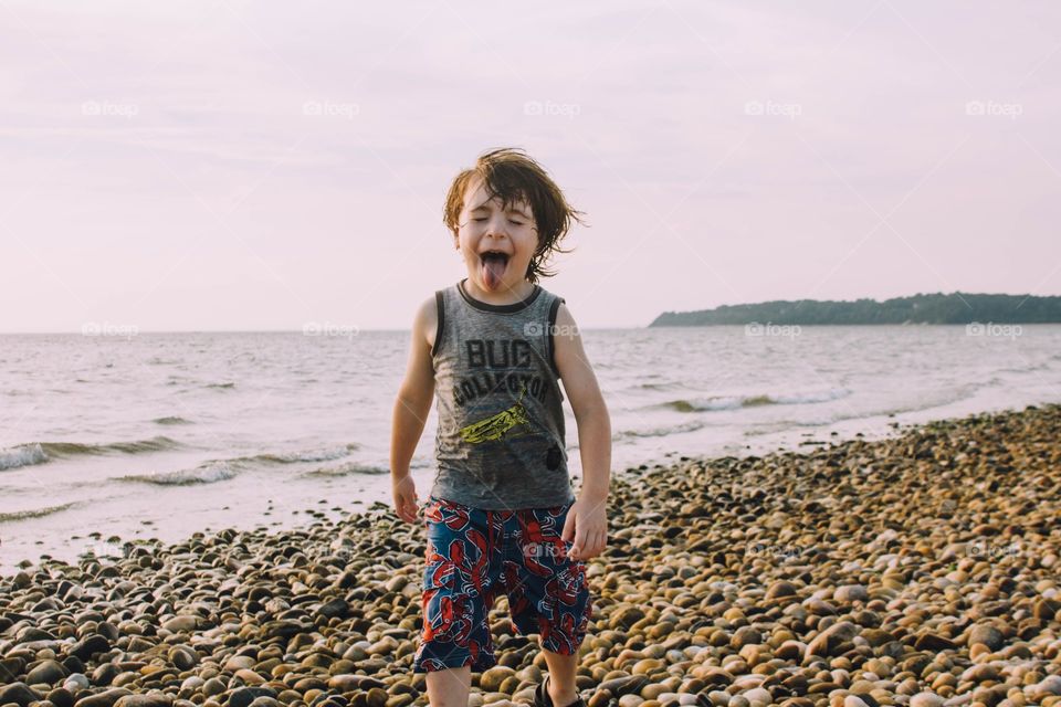 Little boy being silly on the beach