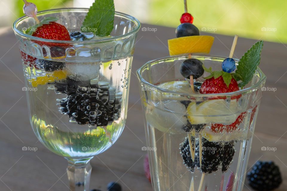 glasses with water and fruits