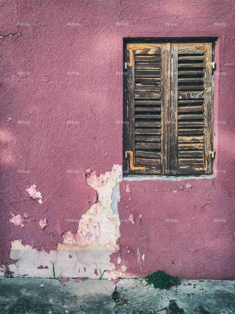 Weathered facade with wooden window