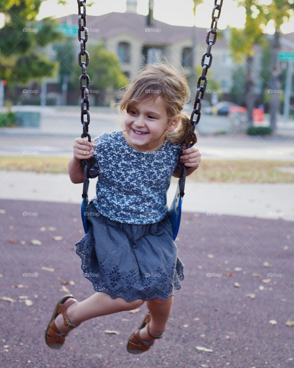 Beautiful girl smiling on a swing