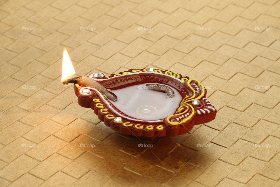 Indian festival Diwali diya oil lamp on golden background