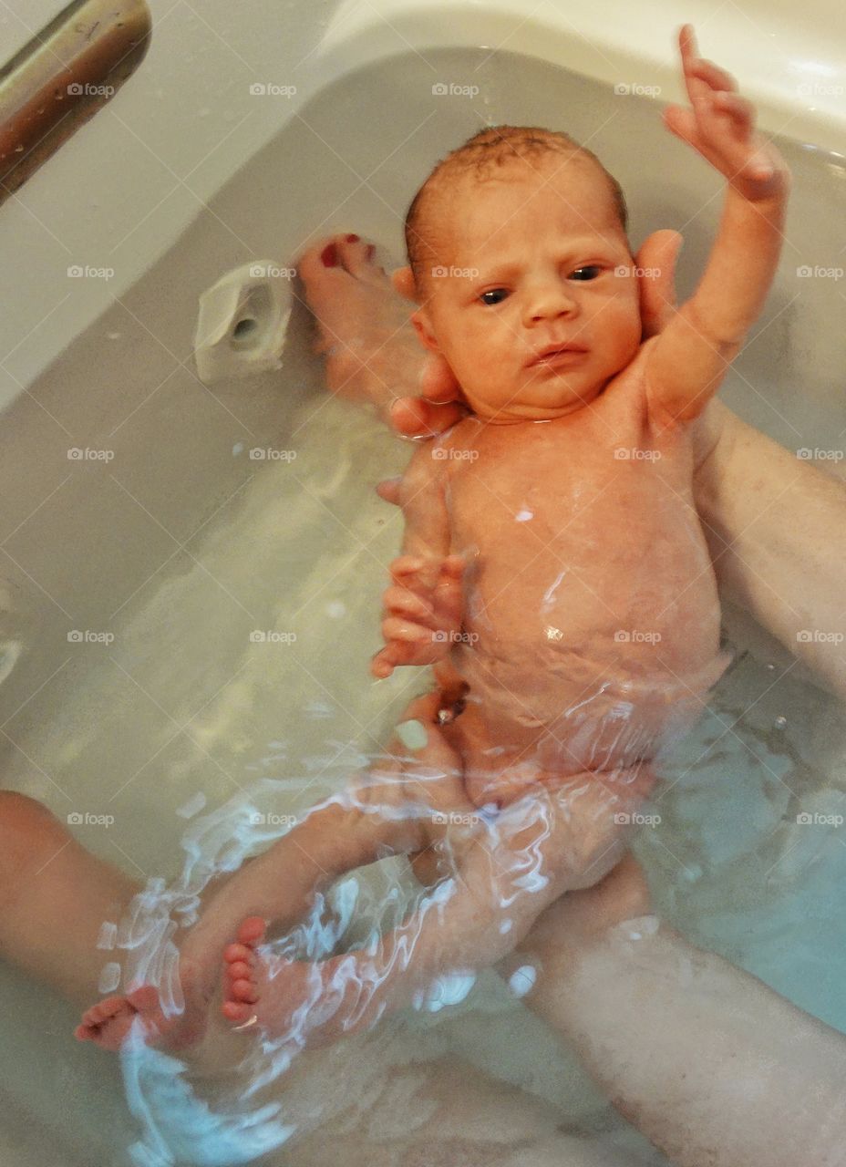 Newborn Infant In The Bath
