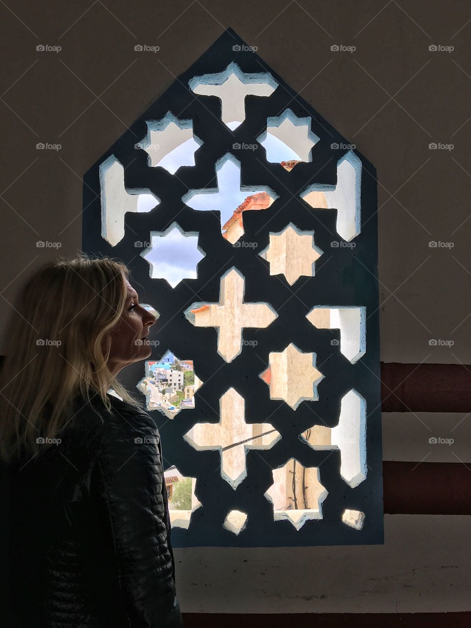 Woman standing near window