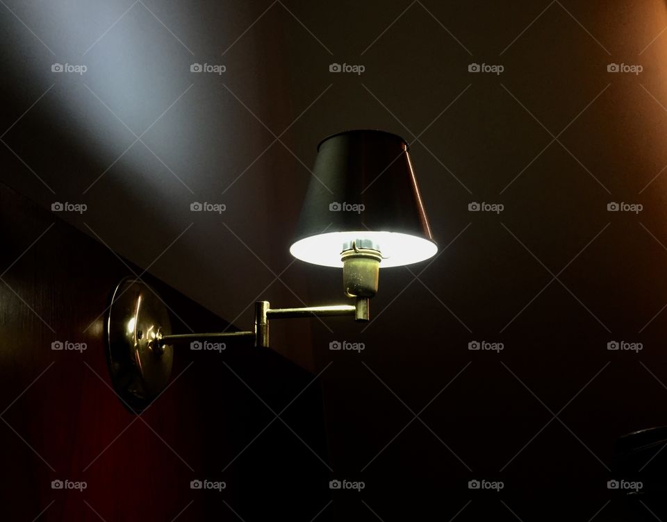 Illuminated electric lamp on wall