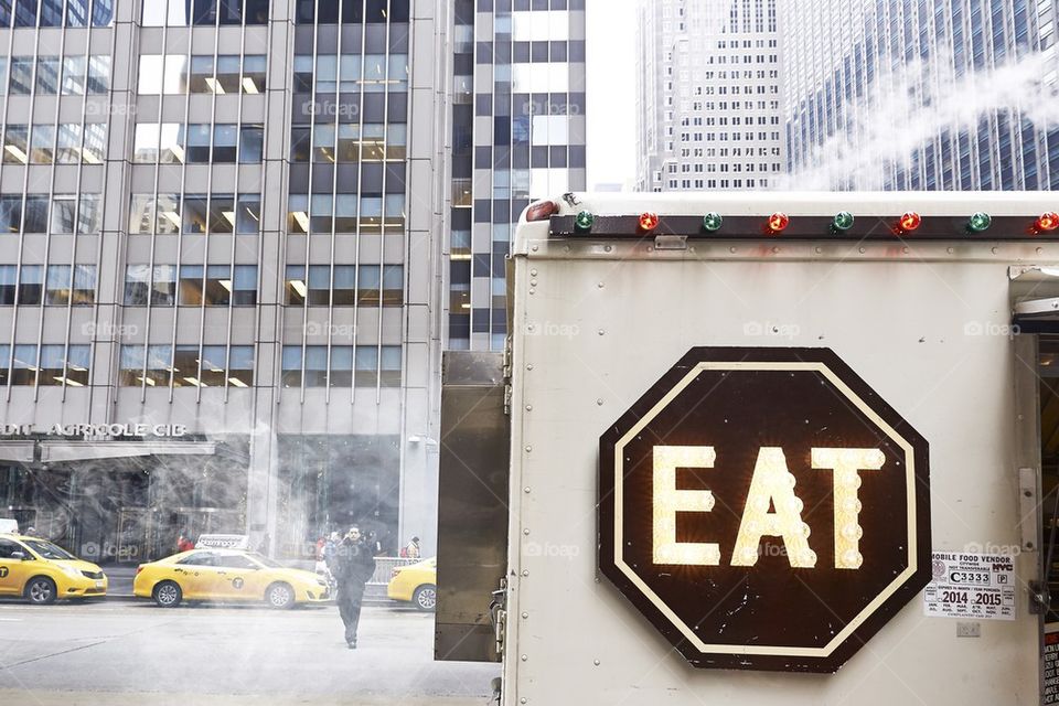 Heavy pollution in streets of New york and EAT food shop in the front. City lifestyle of modern new yorker