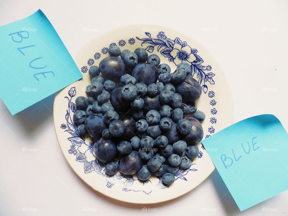 blueberries and plums on a plate