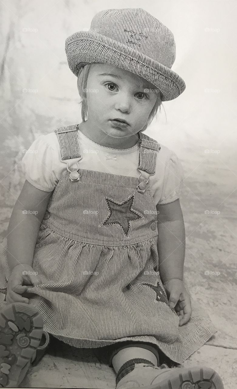 Child posing in overalls