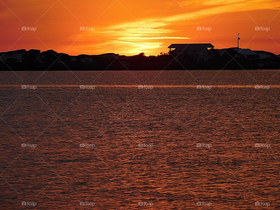 Sunsetting over the beach house on the hill