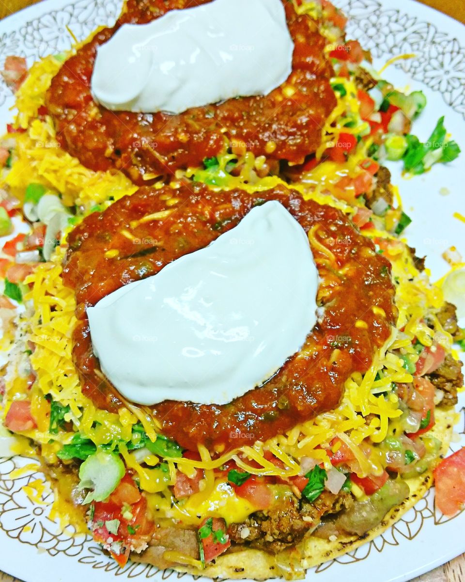 Tostada. With homemade hot sauce and sour cream.