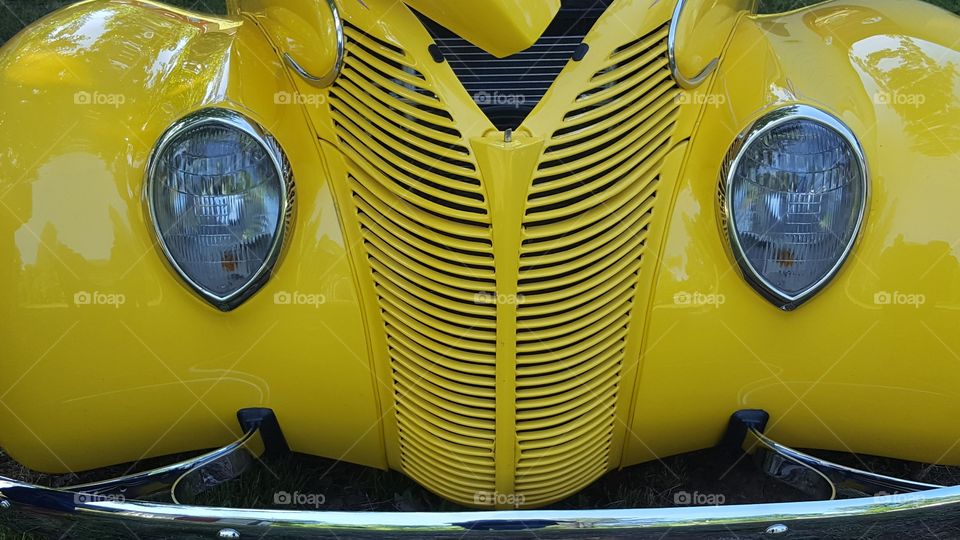 this is the front grill, bumper and headlamps of a classic coupe. I think the headlamps look like eyes.