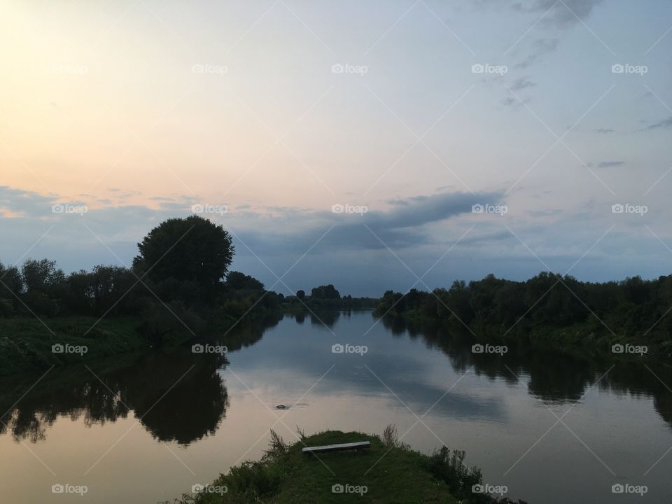 The picture shows the mouth of the Wisłok River to the San River. The picture shows the beauty of nature and clouds