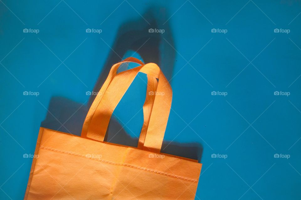 Orange cloth shopping bag on blue background