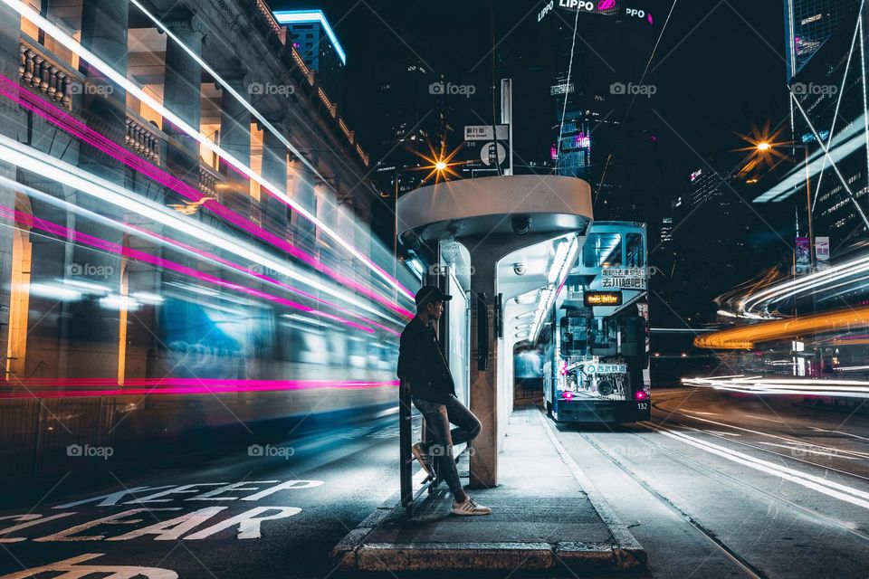 Beauty of long exposure: Portrait shot capturing the light trail of vehicles in Hong Kong street at night