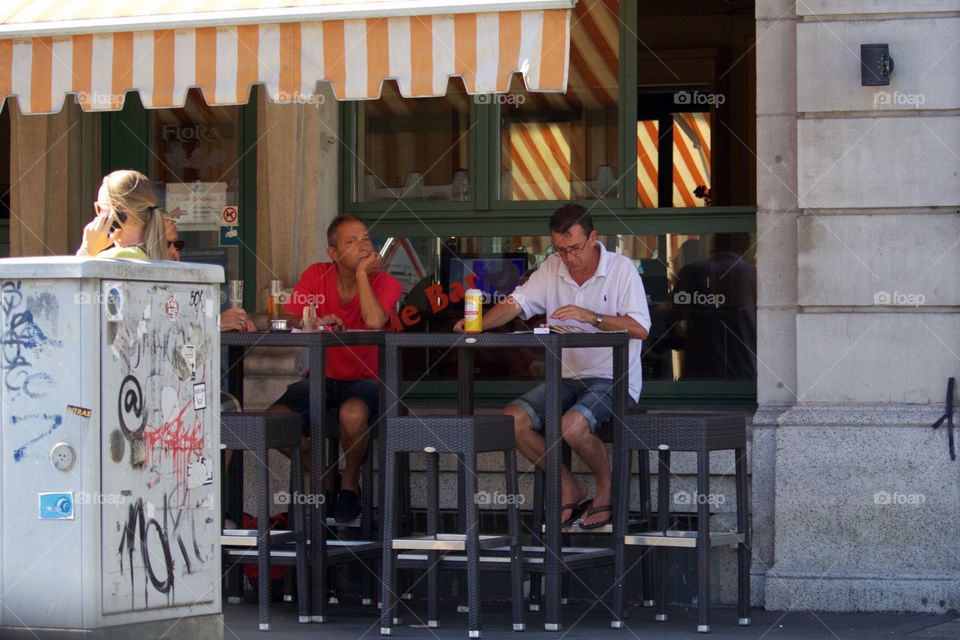 Men Sitting Ouside A Bar In Zürich