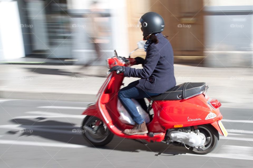 Woman on scooter.