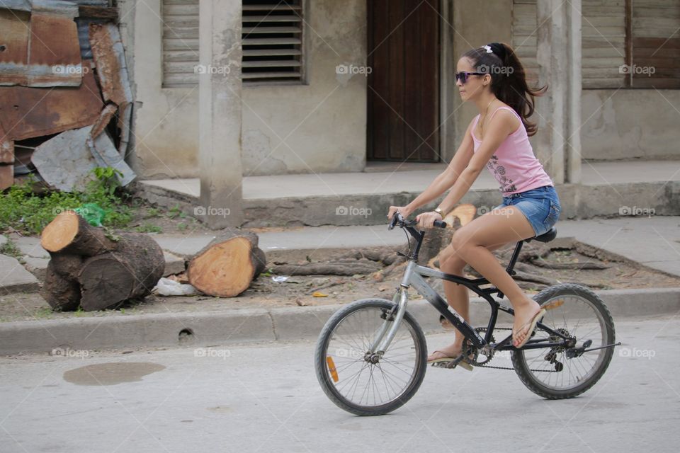 People In Cuba.Young Girl On Bike
