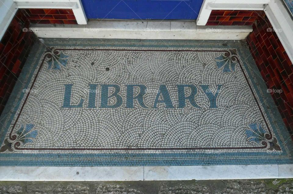 Library. an old mosaic tile floor in the doorway of a former library in Falmouth Cornwall UK