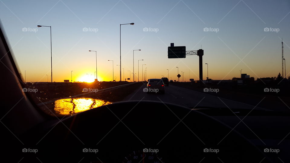 sunrose on road. driving at sunrise