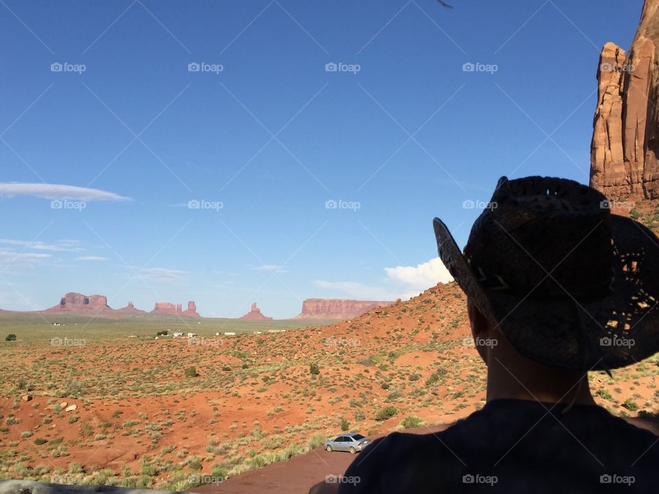The head of a Cow boy looks the horizon at the monument valley tribal park

