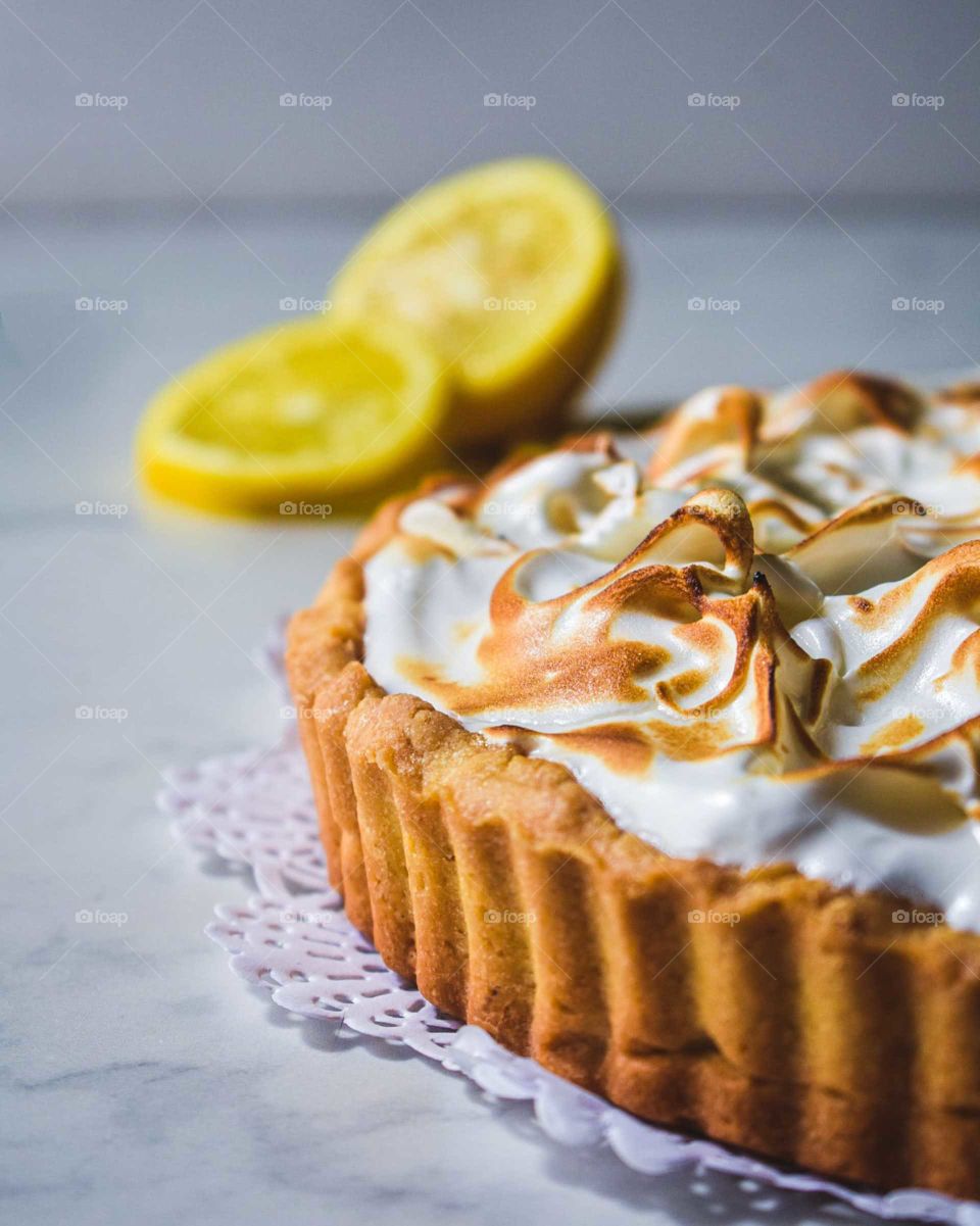 lemon cake on Italian marble decorated with lemon wedges
