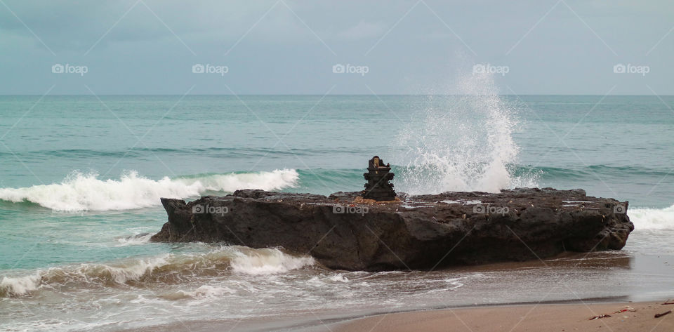 wave hitting a rock. Cangu, Batu bolong beach, Bali.