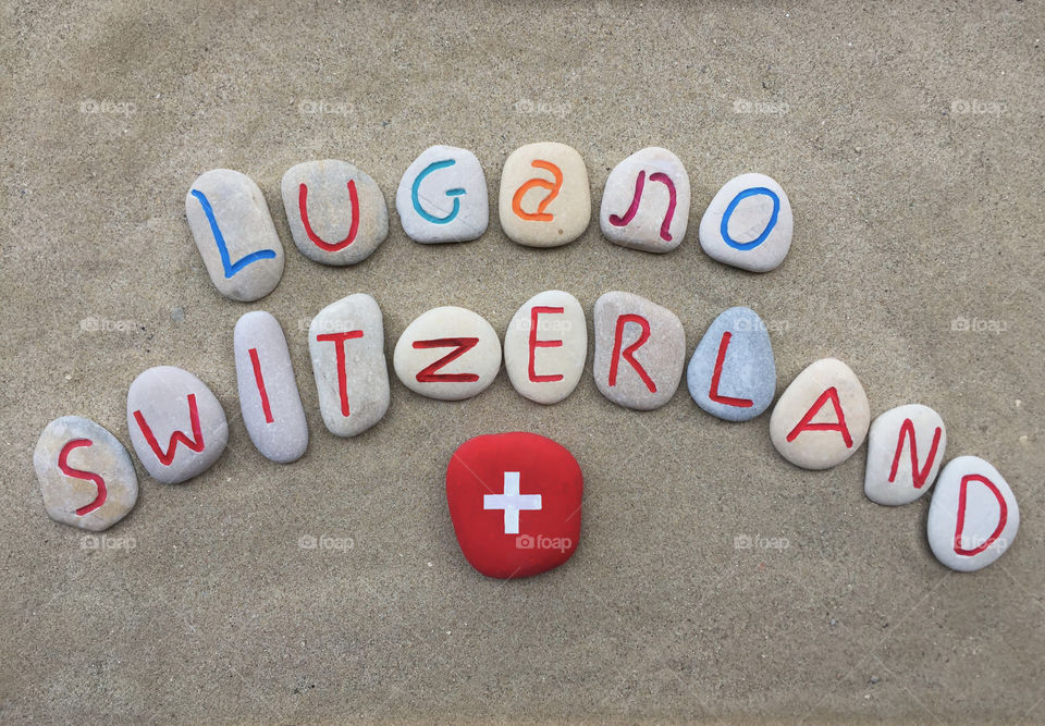 Lugano, Switzerland on stones . Carved stones souvenir of Lugano, Switzerland