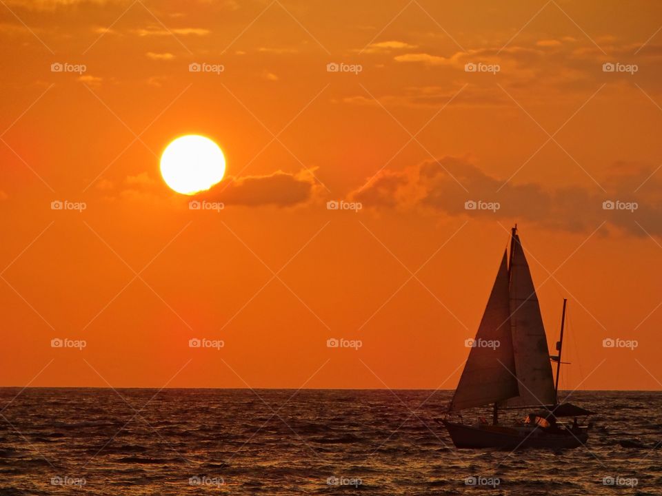 Sailboat On The Ocean At Sunset
