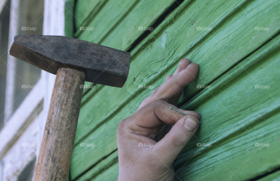 A man hammers a nail