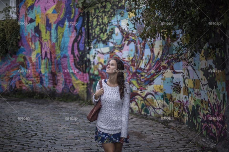 Afternoon stroll . A girl passes by an alley in São Paulo, Brazil 