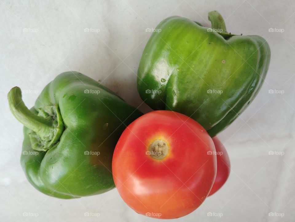 red tomato and green chilli both are very beautiful generally found everywhere nature