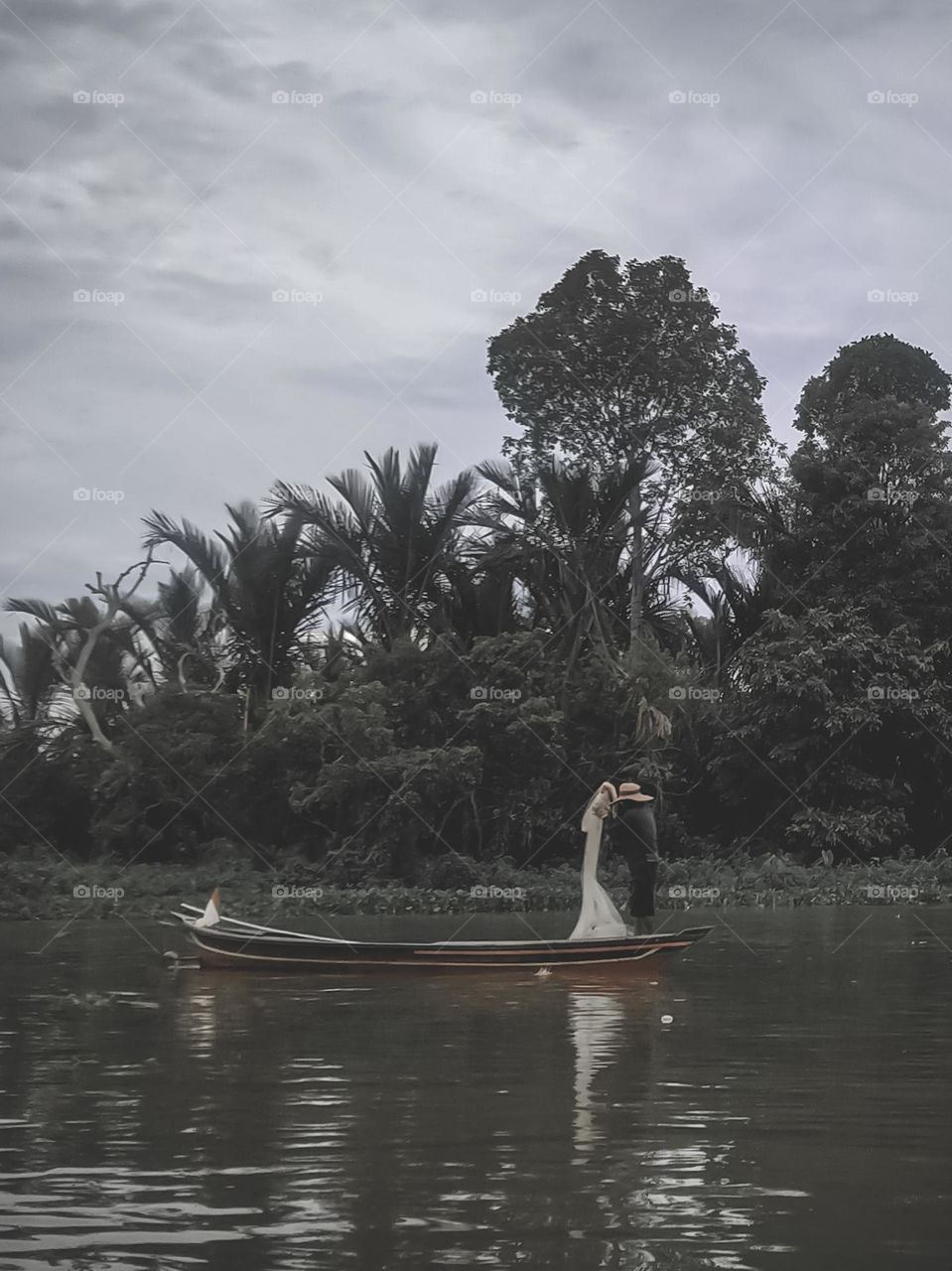 Fisherman looking for fish in the river