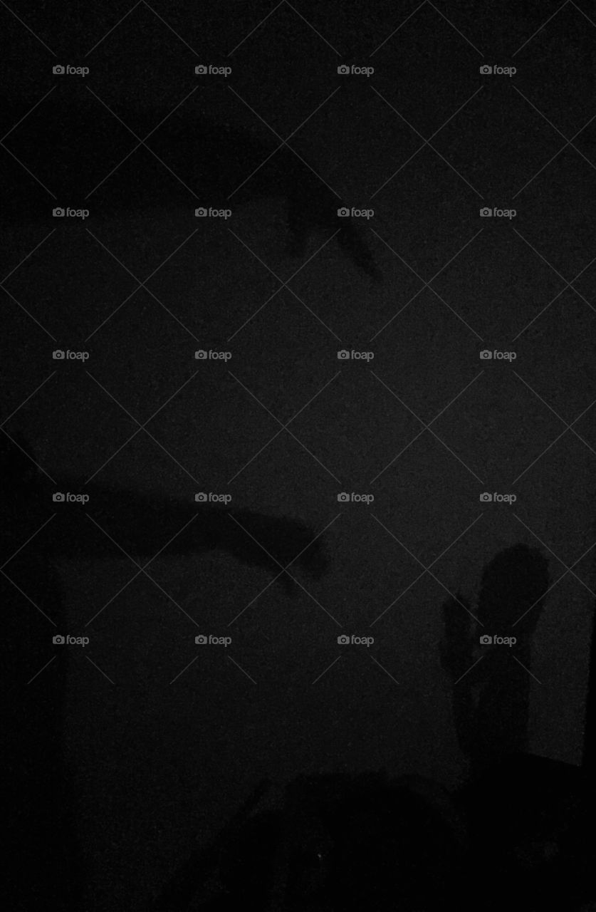 A boy pleading a demon in the shadows