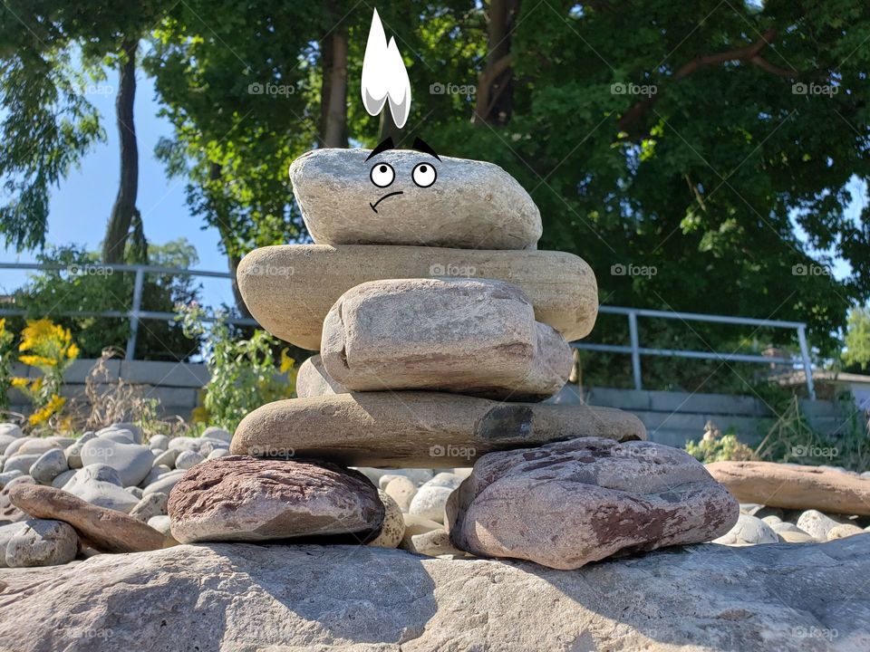 Inuksuk statue made of rocks with paniced expression on face