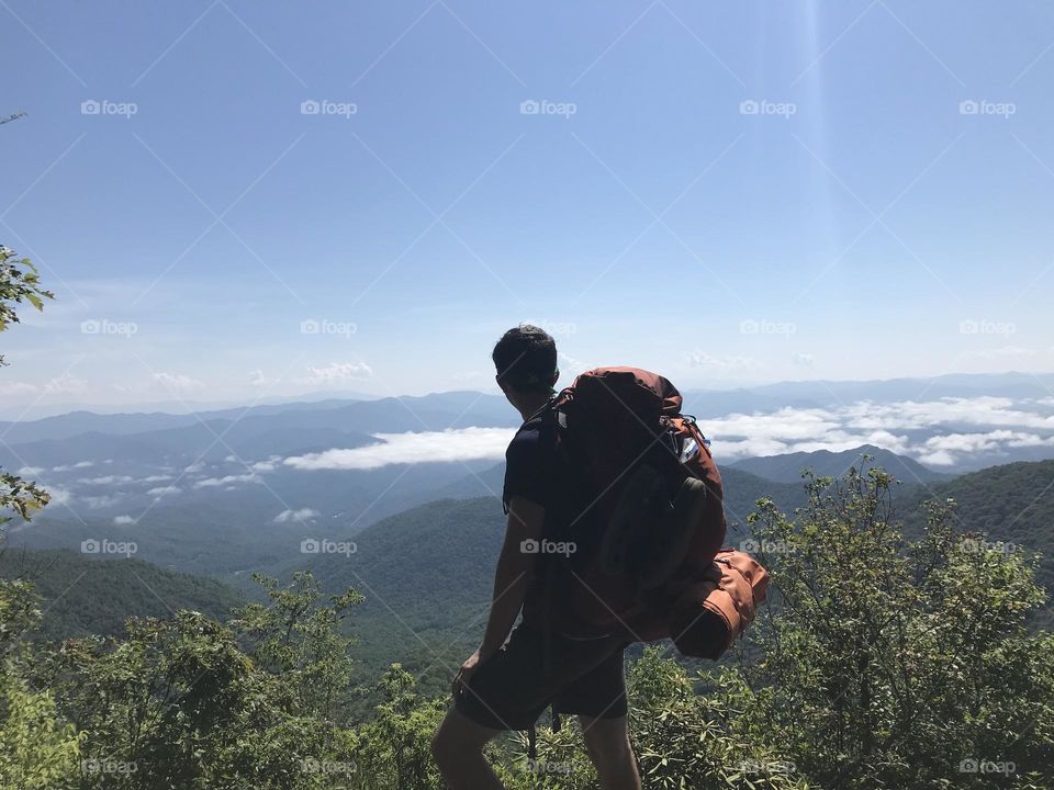 Backpacker standing on peak in Smokey Mountain 