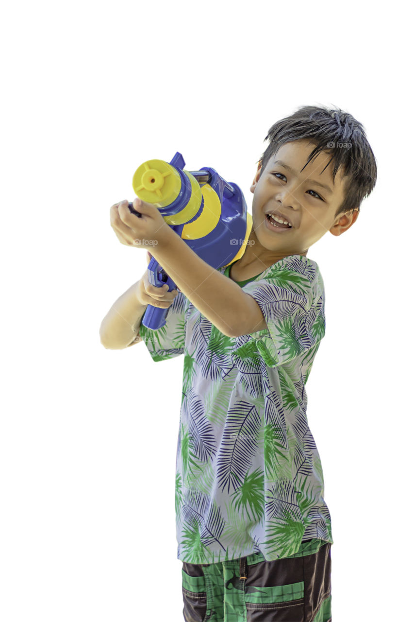 Asian boy holding a water gun play Songkran festival in Thailand on a white background with clipping path.