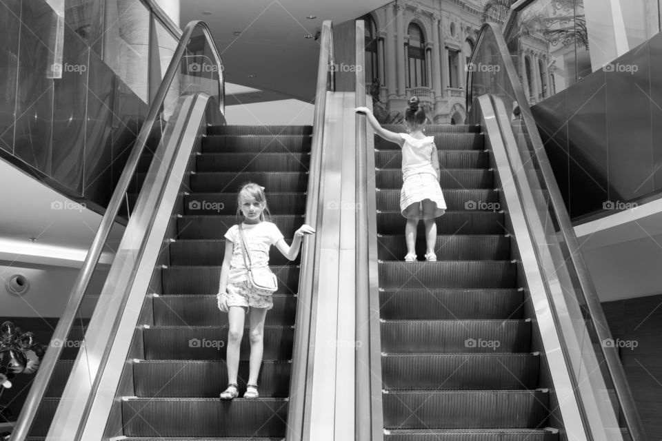 Two girls on staircase in mall