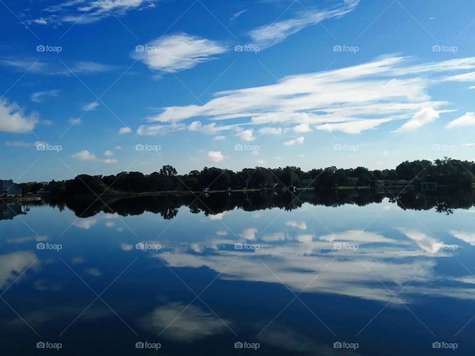 beautiful mirrorlike sky reflections off lake