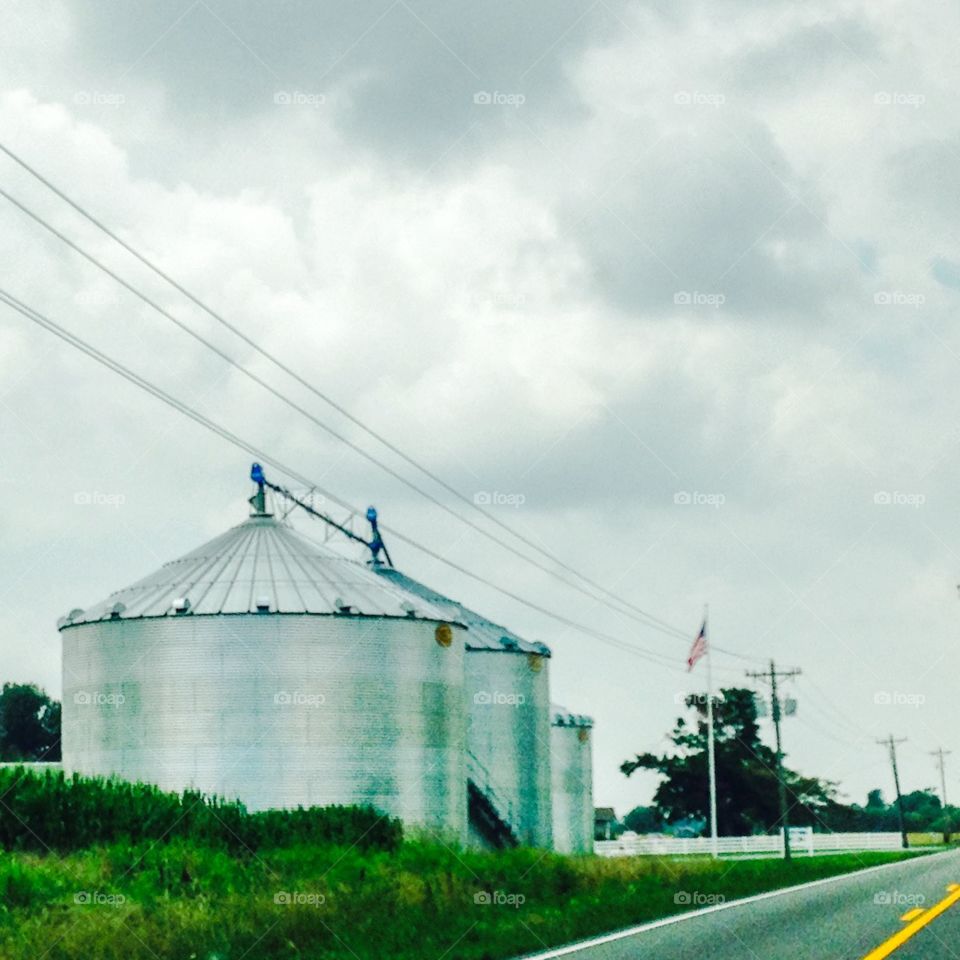Grain elevators in Kentucky . Love the American flag waving proudly as I drive by this Kentucky farm. 