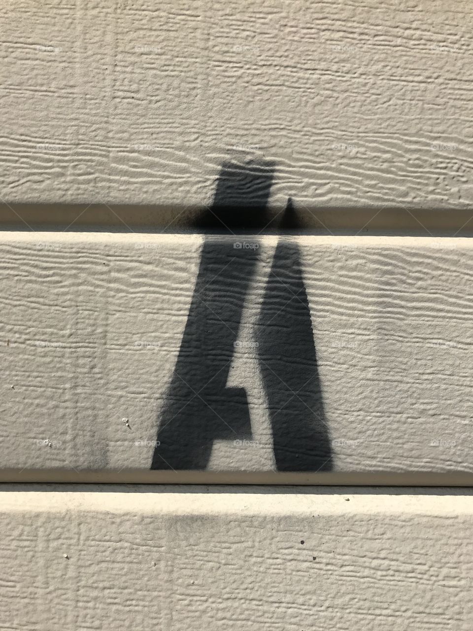 A stenciled “A” on the garage door. A simple letter design that is quite apparent.