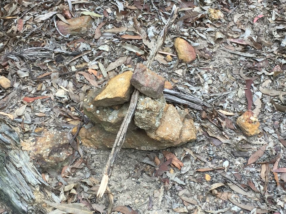 Rocks stacked with a stick