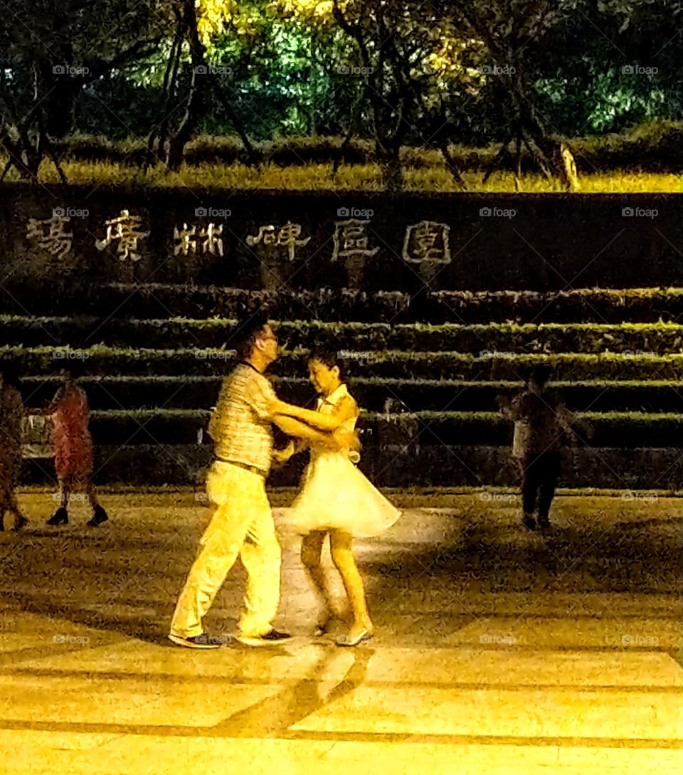 Staying in good shape: ballroom dancing night club outdoor activity in the park.