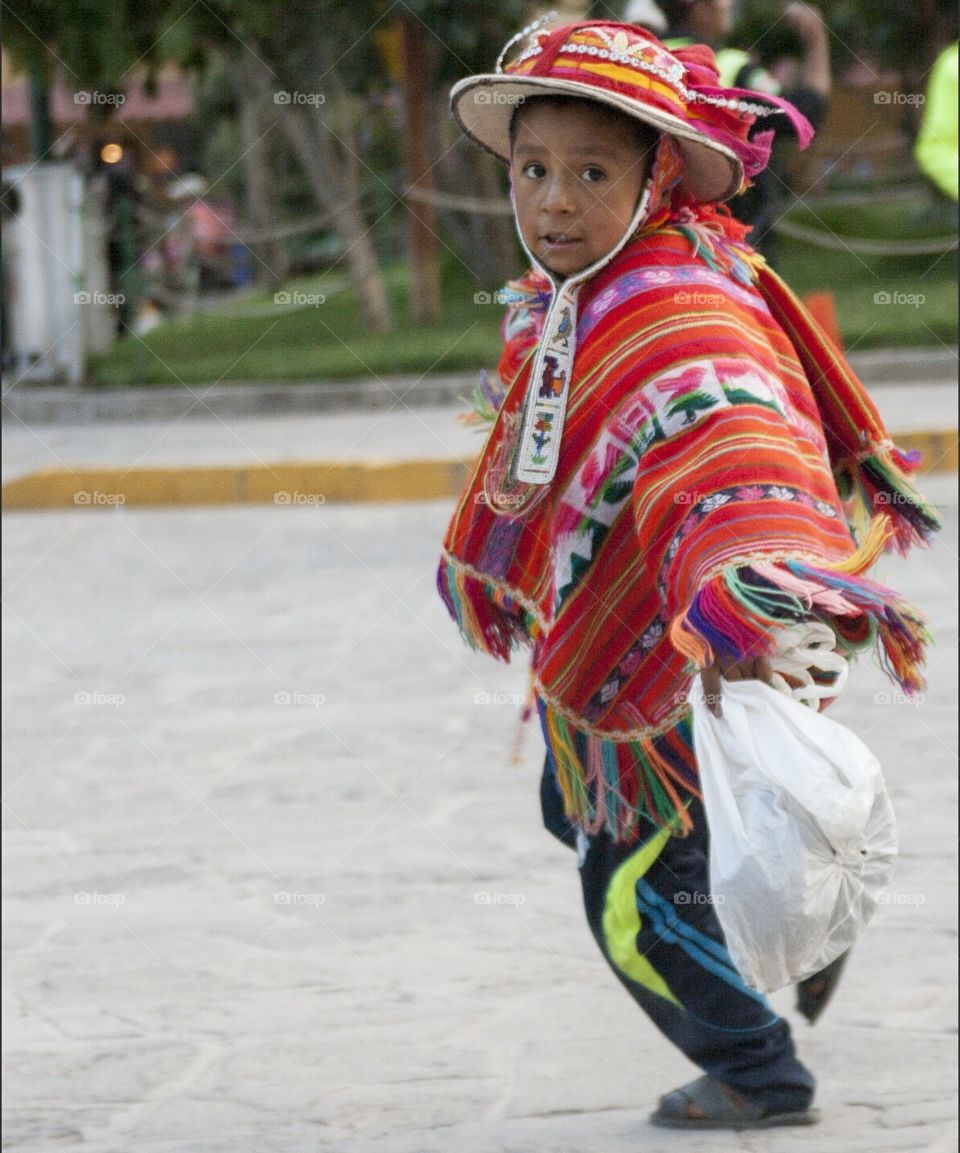 Peruvian kid running on street