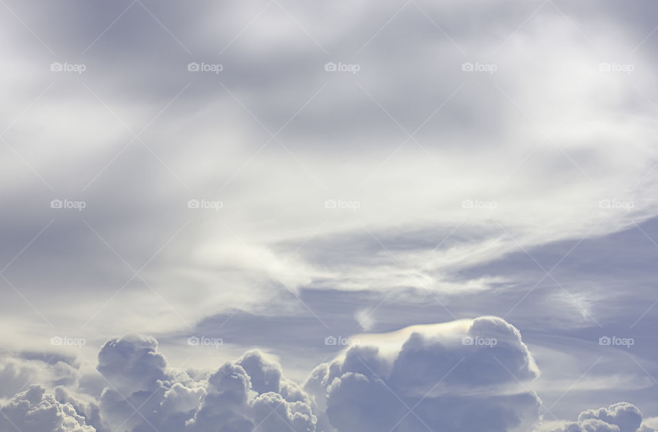 The beauty of the sky with clouds and the sun in summer.