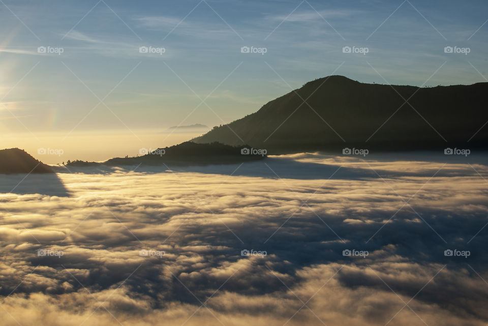 Sunrise above the clouds in the mountains 