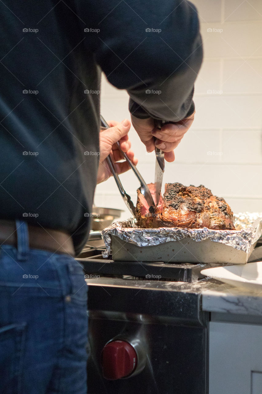 Cutting the prime rib at a special family dinner. 