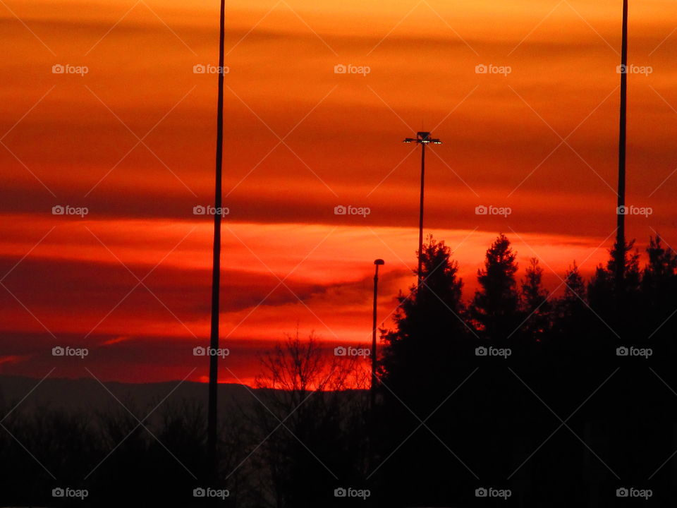 watching the sunrise while turning the skies red orange and yellow at the Sacramento international airport