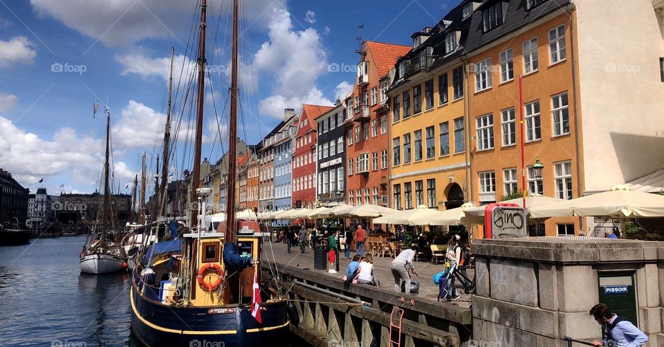 Famous street in Copenhague, Denmark. Distinct beautiful architecture and local business along the canal