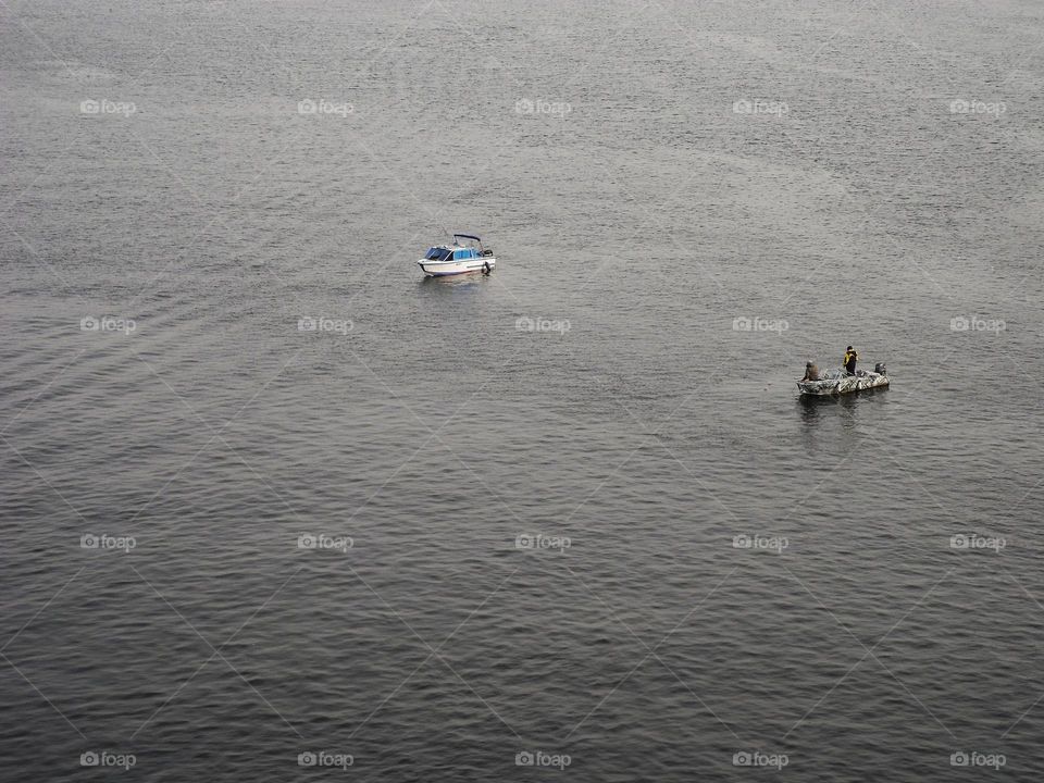 two fishing boats are fishing on the Dnieper river