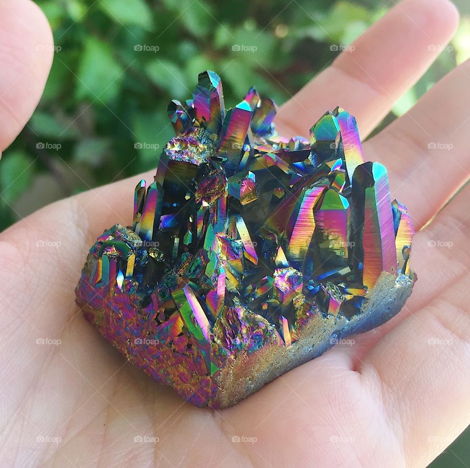 A rainbow aura quartz crystal cluster.